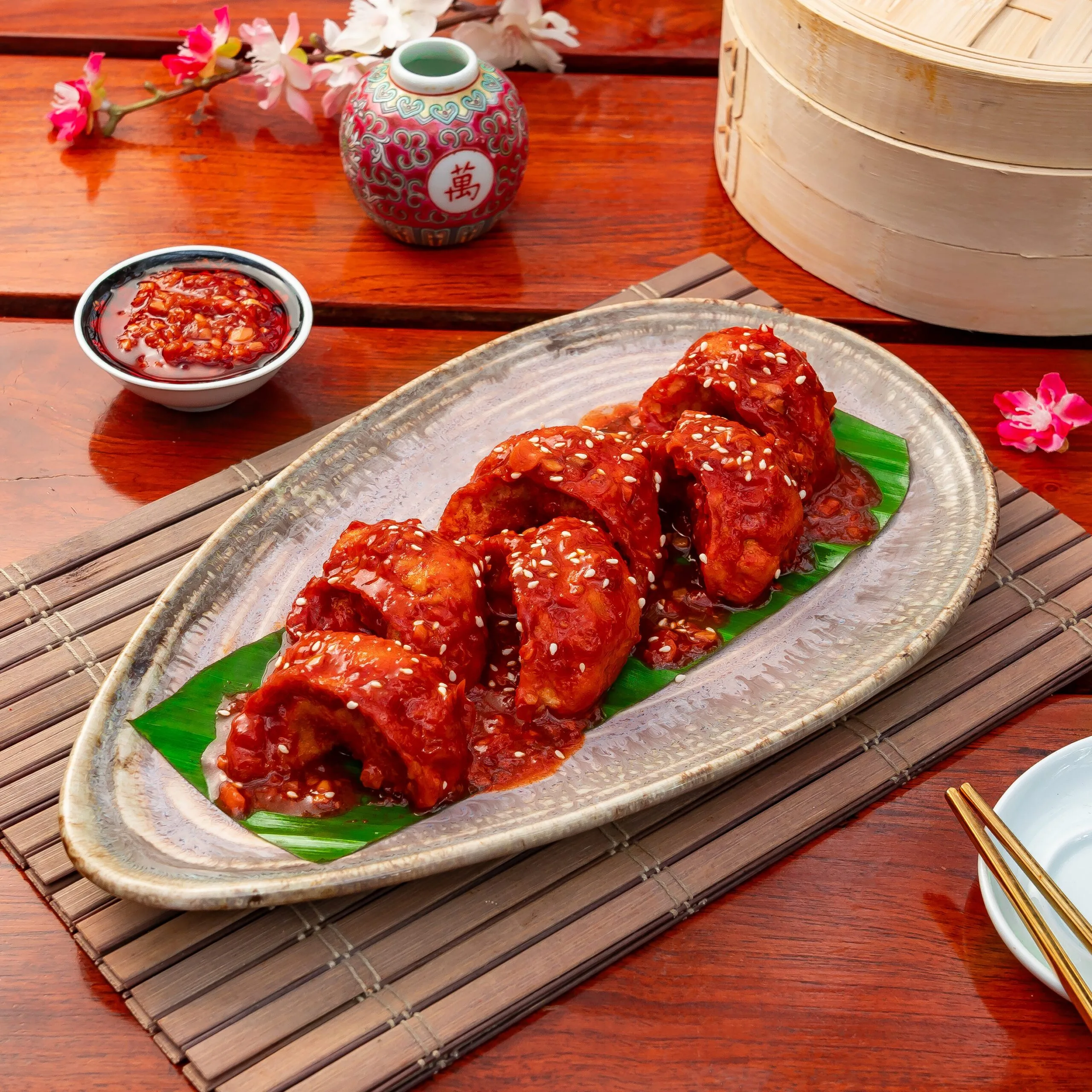 Rowdy’s saucy red momos with sesame, chilli dip and a bamboo steamer